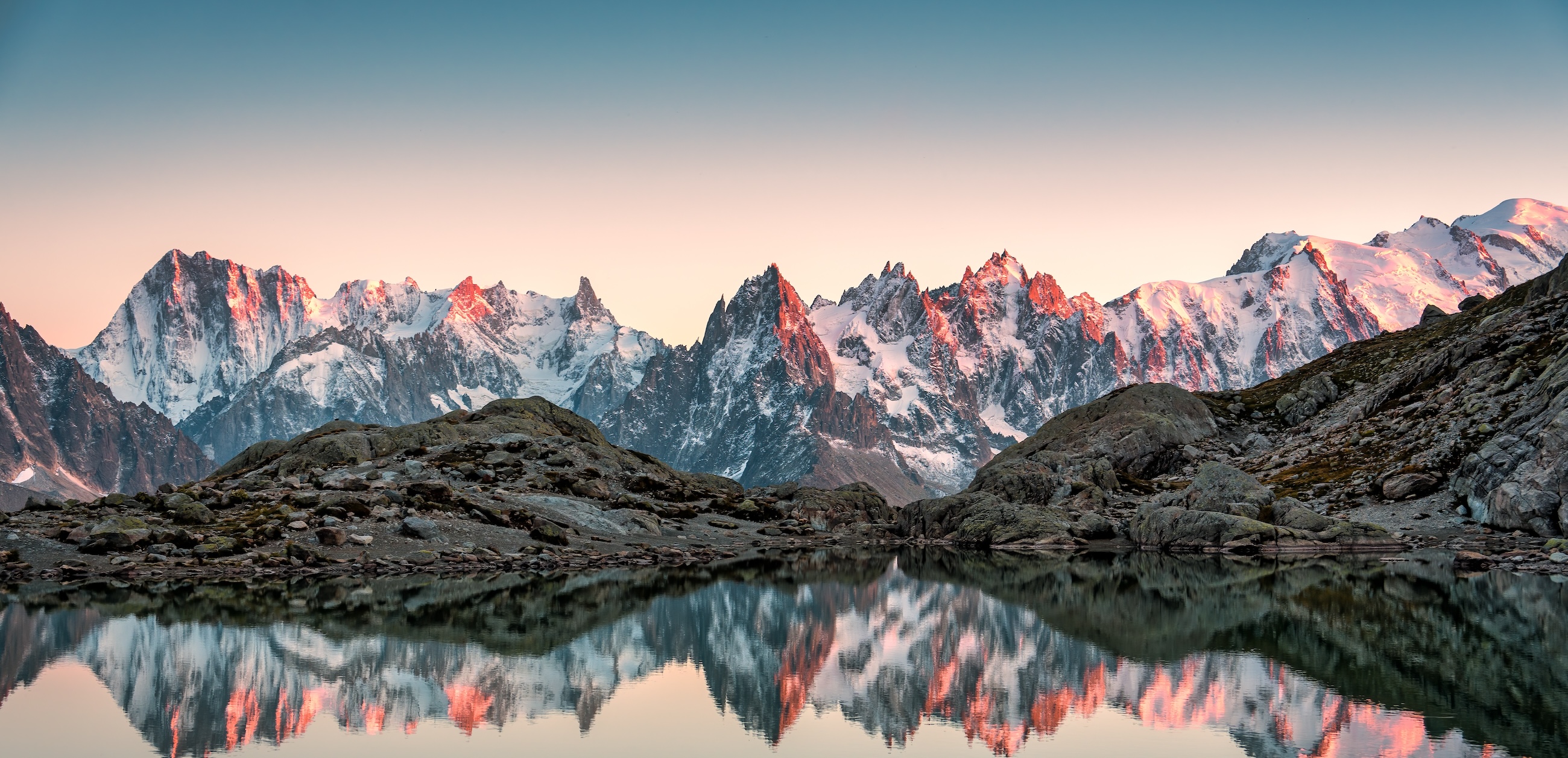 Mountain peaks reflected in a still alpine lake